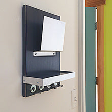 Load image into Gallery viewer, Black mail holder mounted on the wall. The black of the wooden body gives good contrast with the metal mail holder, key hooks and shelf border.