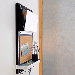 Side shot of the sleek black colored organizer with a small plant on the attached shelf.