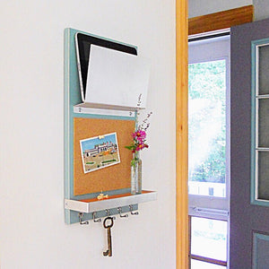 Angled shot of the light blue cork board organizer in the living room.