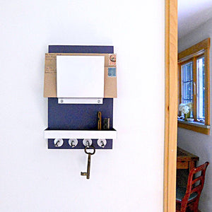 Navy blue mail holder mounted on the wall.